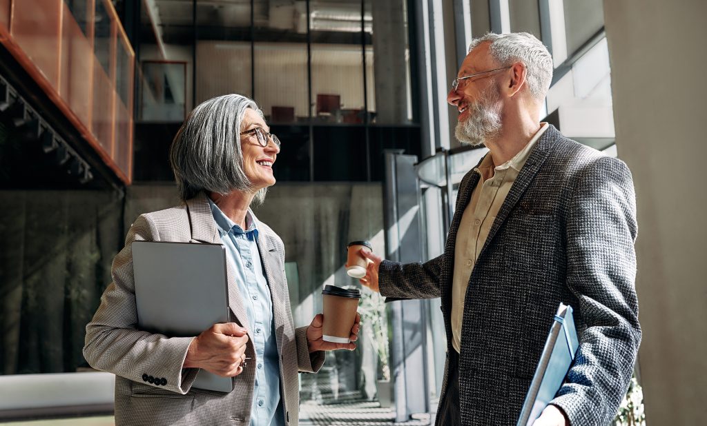 Two older businesspeople in lobby